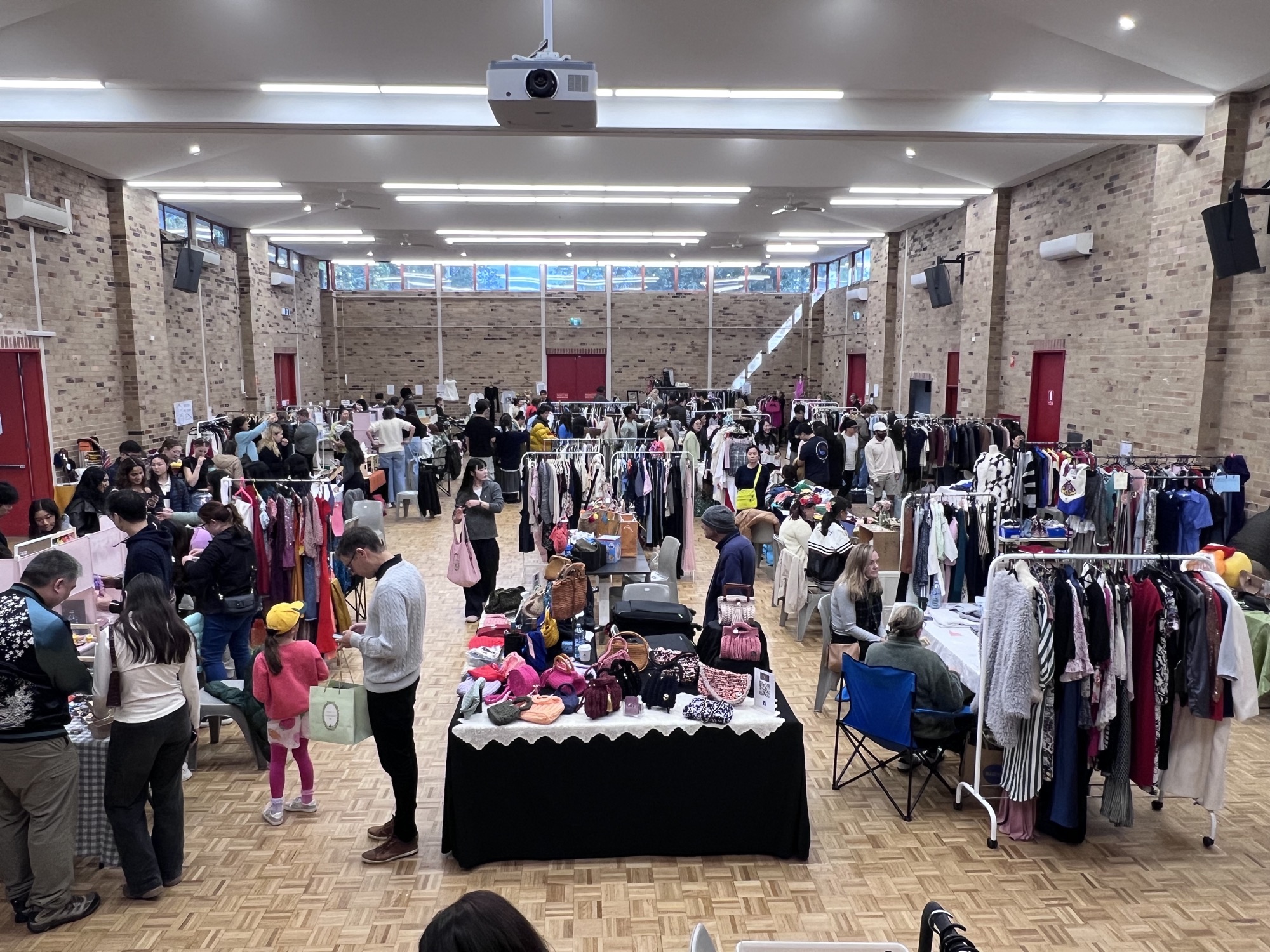 Wide view of the Cherrybrook Community and Cultural Centre hall filled with market stalls and visitors
