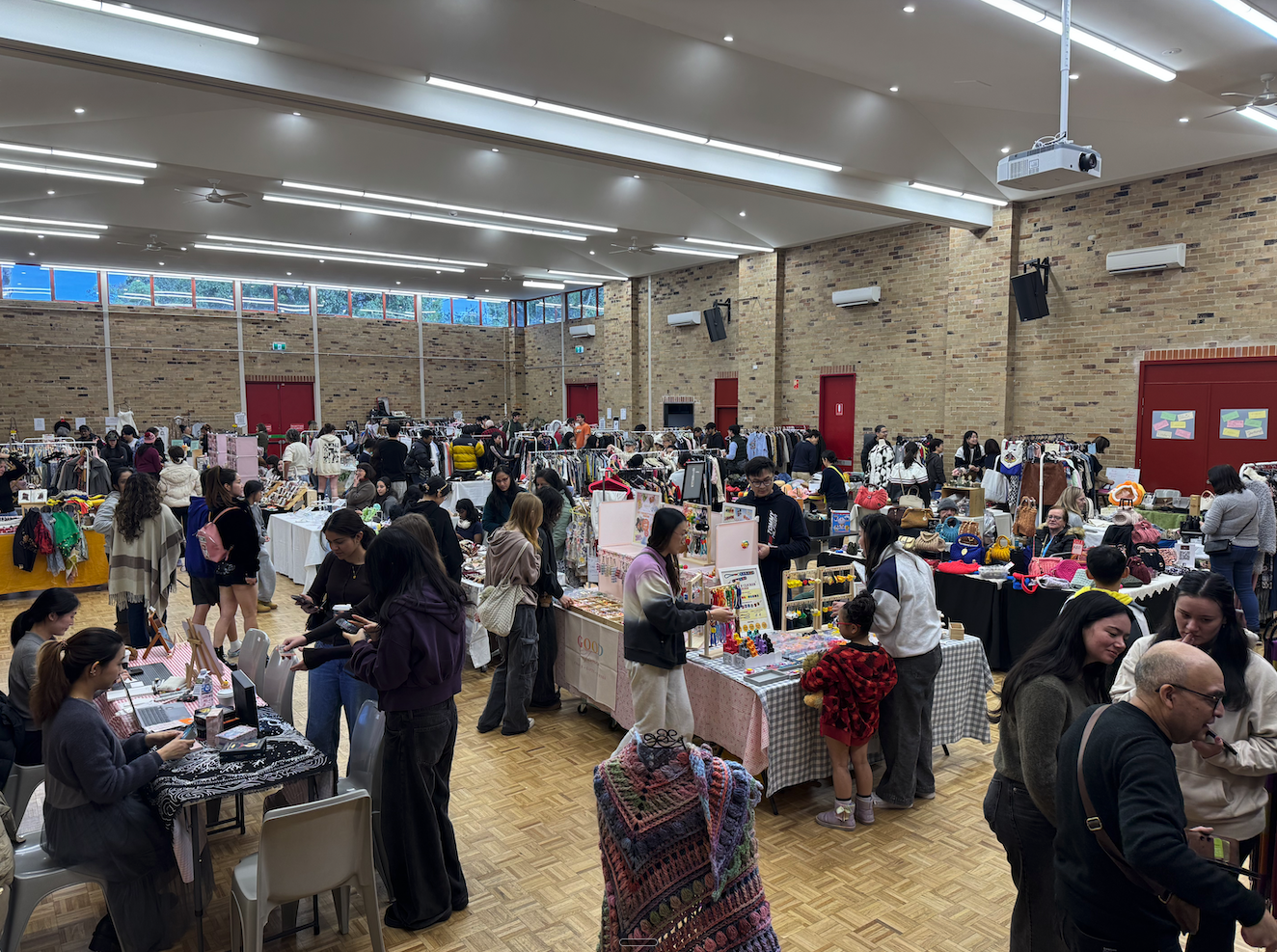 Wide view of Hills Style Market venue with clothing stalls